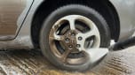 Alloy wheel being cleaned with pressure washer